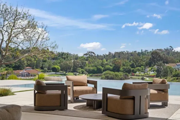 a view of a patio with couches and a big yard