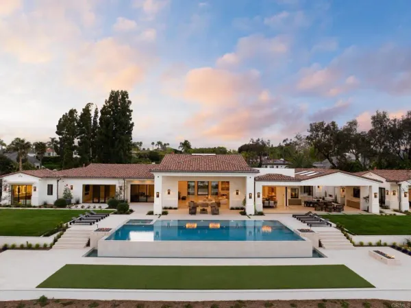 a front view of residential houses with yard and green space