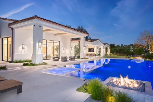 a view of a house with swimming pool and sitting area