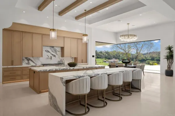 a large kitchen with a table and chairs in it