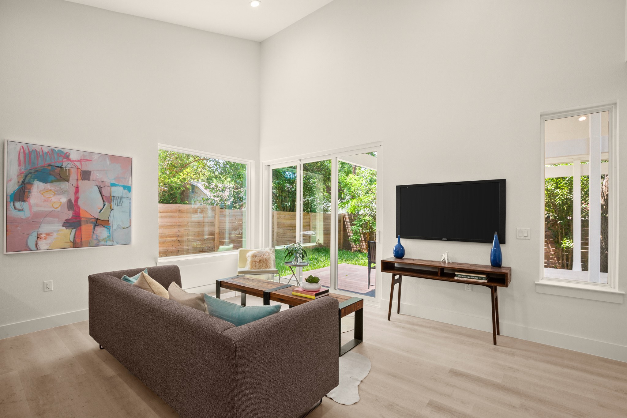 3003 Ray Wood Drive, Unit 2 Austin, TX 78704 - Photo 16 of 28 Living room featuring light wood-style flooring, a high ceiling, healthy amount of natural light, and recessed lighting