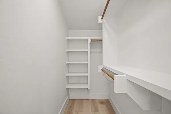 a bedroom with a bed and wooden floor