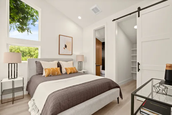 a bedroom with a bed and a window