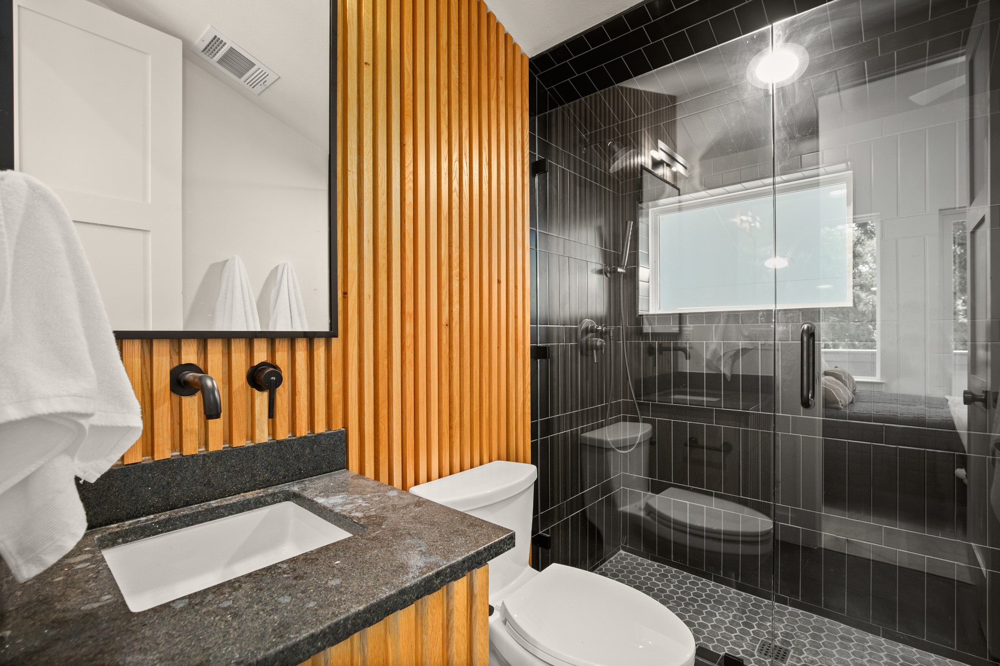 3003 Ray Wood Drive, Unit 2 Austin, TX 78704 - Photo 5 of 28 Bathroom featuring vanity, a stall shower, and wooden walls