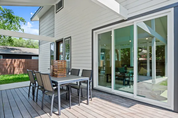 a view of a house with backyard and sitting area