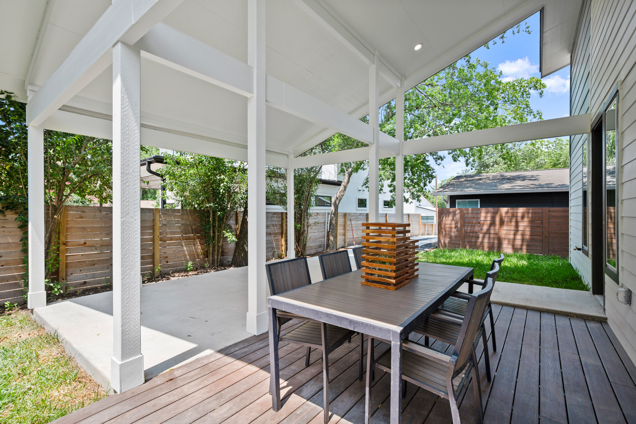 3003 Ray Wood Drive, Unit 2 Austin, TX 78704 - Photo 9 of 28 Wooden terrace featuring outdoor dining area, a fenced backyard, and a patio