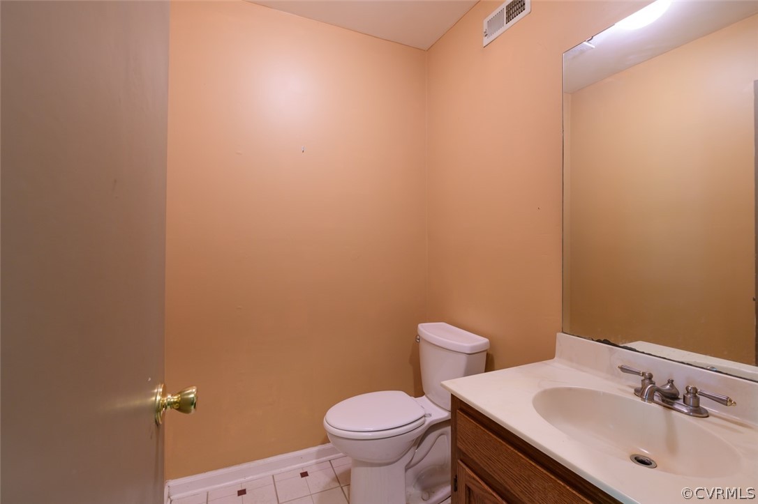 4506 Rabbit Foot Lane Chesterfield, VA 23236 - Photo 8 of 32 a bathroom with a sink a toilet and a mirror
