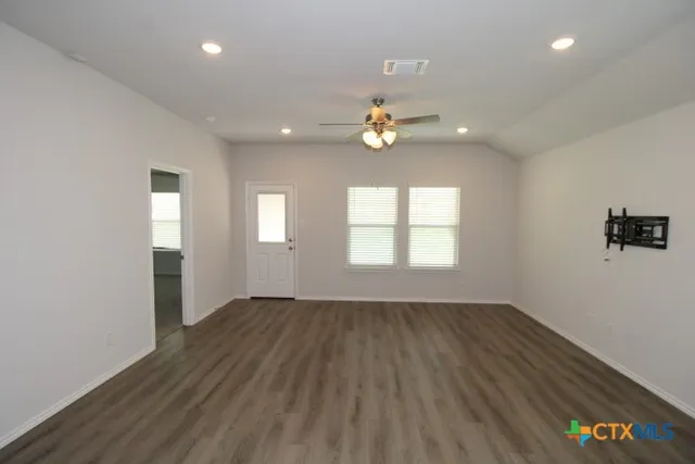 wooden floor in an empty room with a window