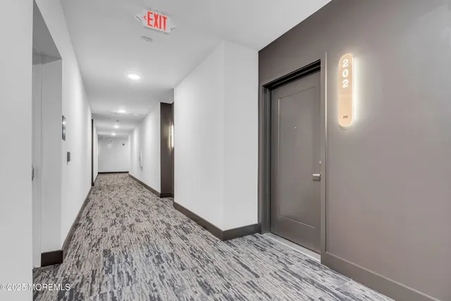 a view of hallway with wooden floor