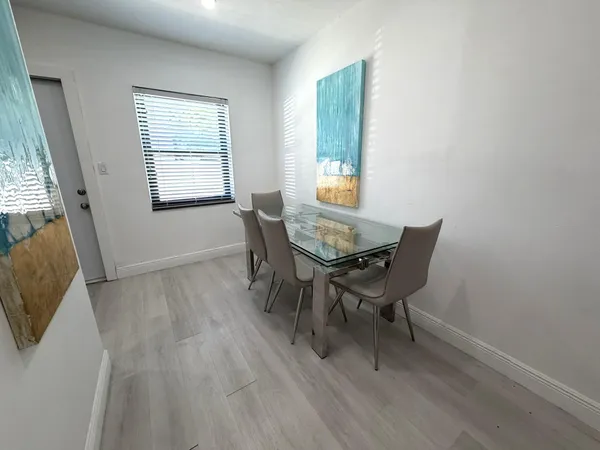 a view of a dining room with furniture and a window