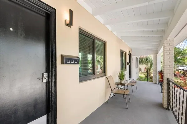 a view of a porch with furniture and front door