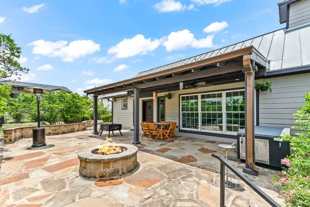 a front view of house with yard outdoor seating and barbeque oven
