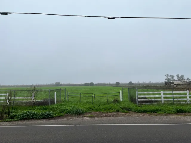 a view of a field with a street view