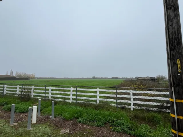 a view of a lake with outdoor space and bench in back