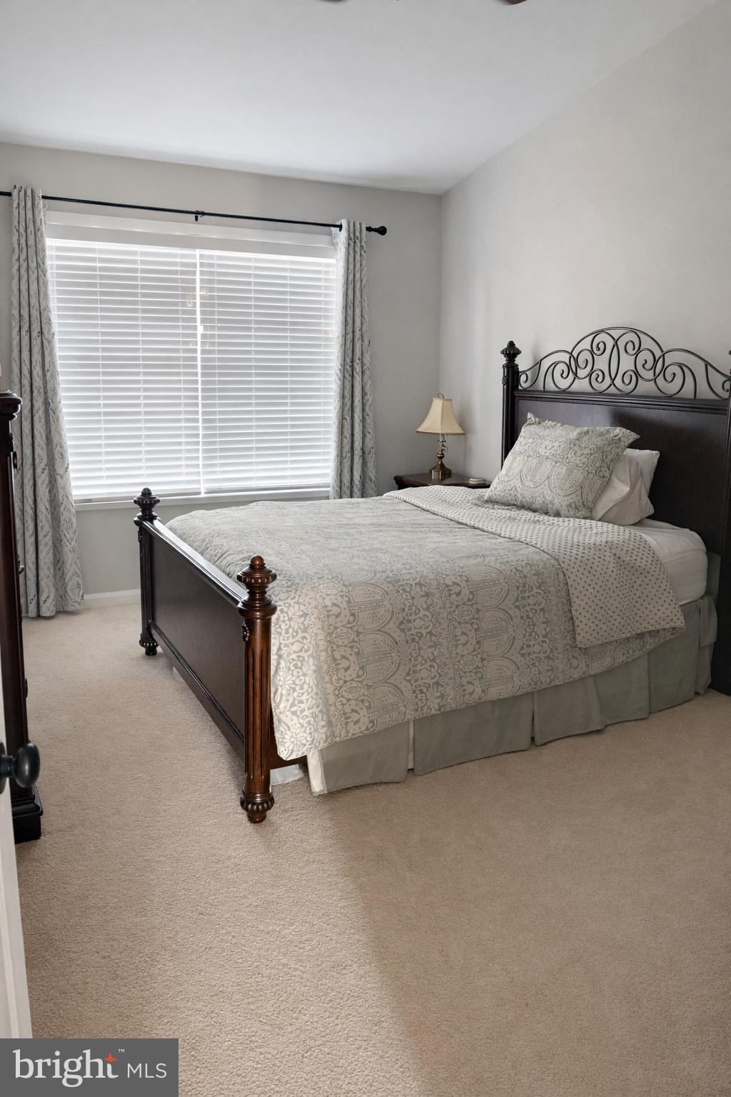 8476 Tackhouse Loop Gainesville, VA 20155 - Photo 12 of 16 a bedroom with a bed and a window