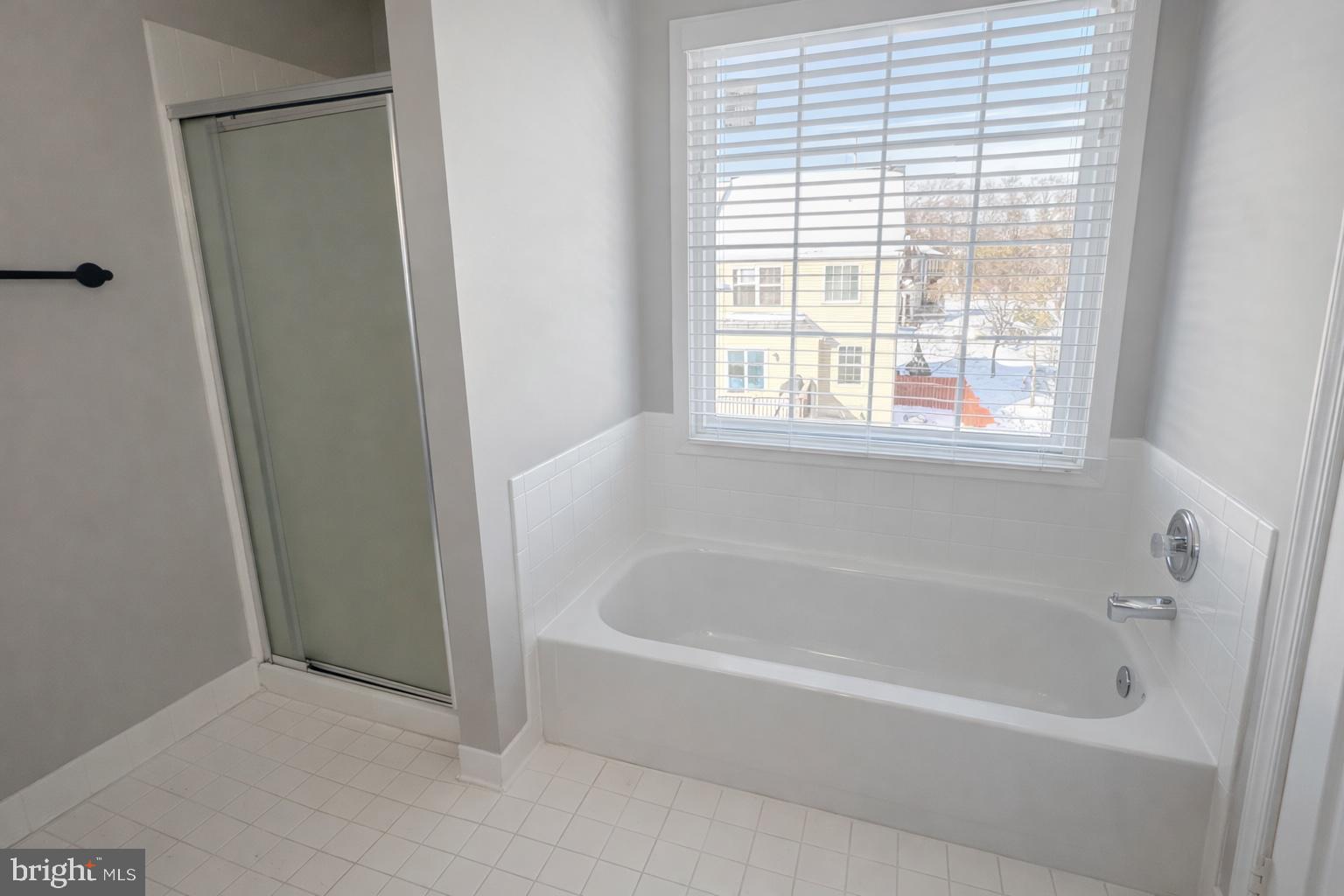 8476 Tackhouse Loop Gainesville, VA 20155 - Photo 14 of 16 a white bath tub sitting next to a window