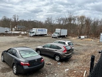 a cars parked in a dirt yard