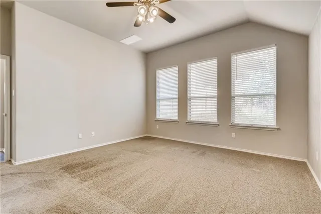 an empty room with a empty space and windows