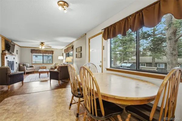 a view of a dining room with furniture window and outside view