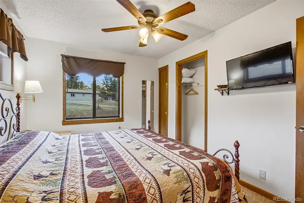a bedroom with a large bed and a flat screen tv