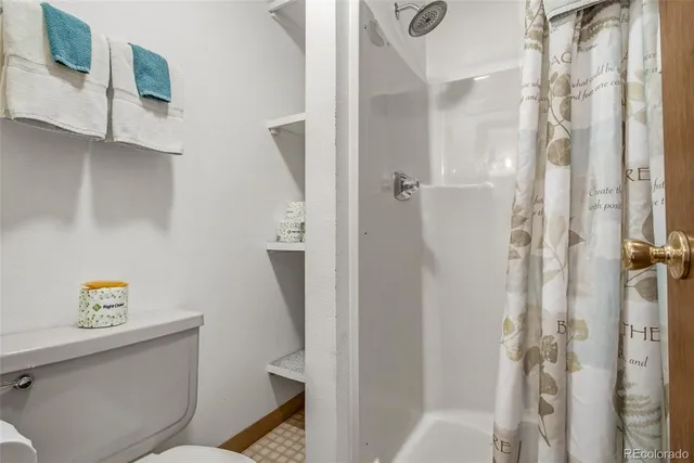 a bathroom with a shower toilet and sink
