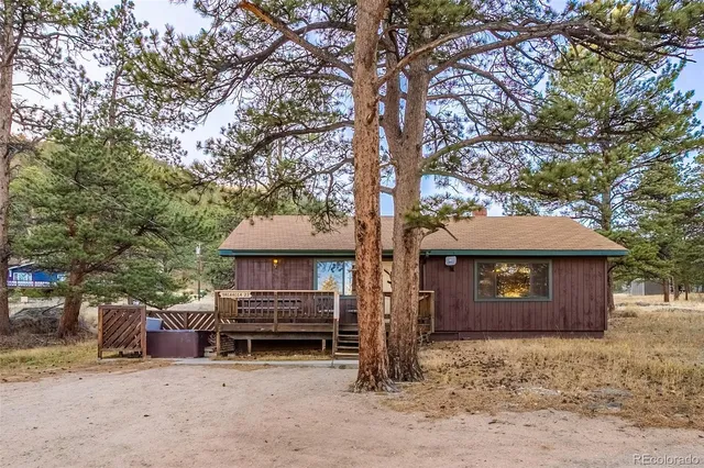 a wooden bench sitting in front of a house