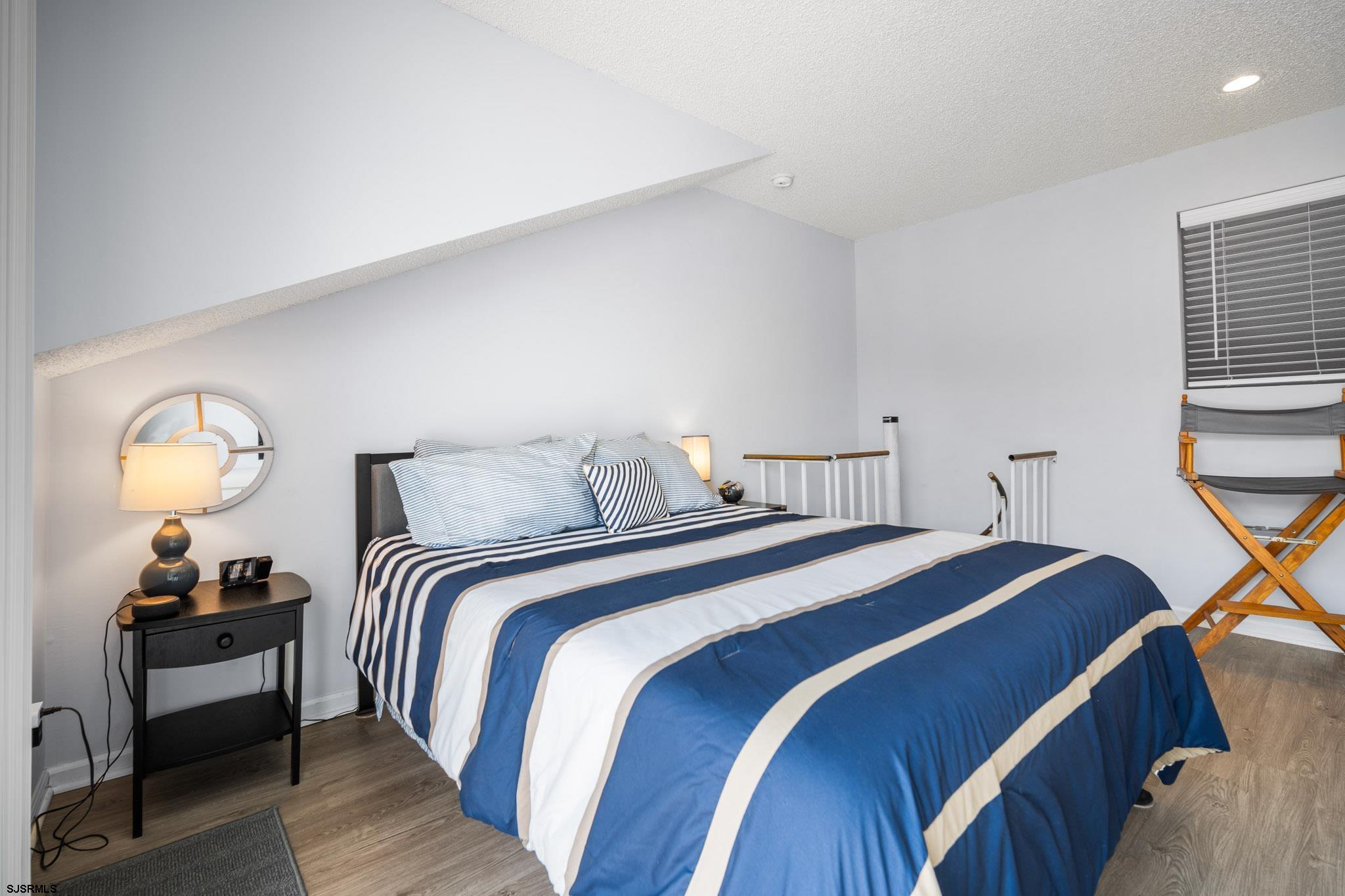 323 44th Street South, Unit 23 Brigantine, NJ 08203 - Photo 21 of 33 a bedroom with double bed and a lamp