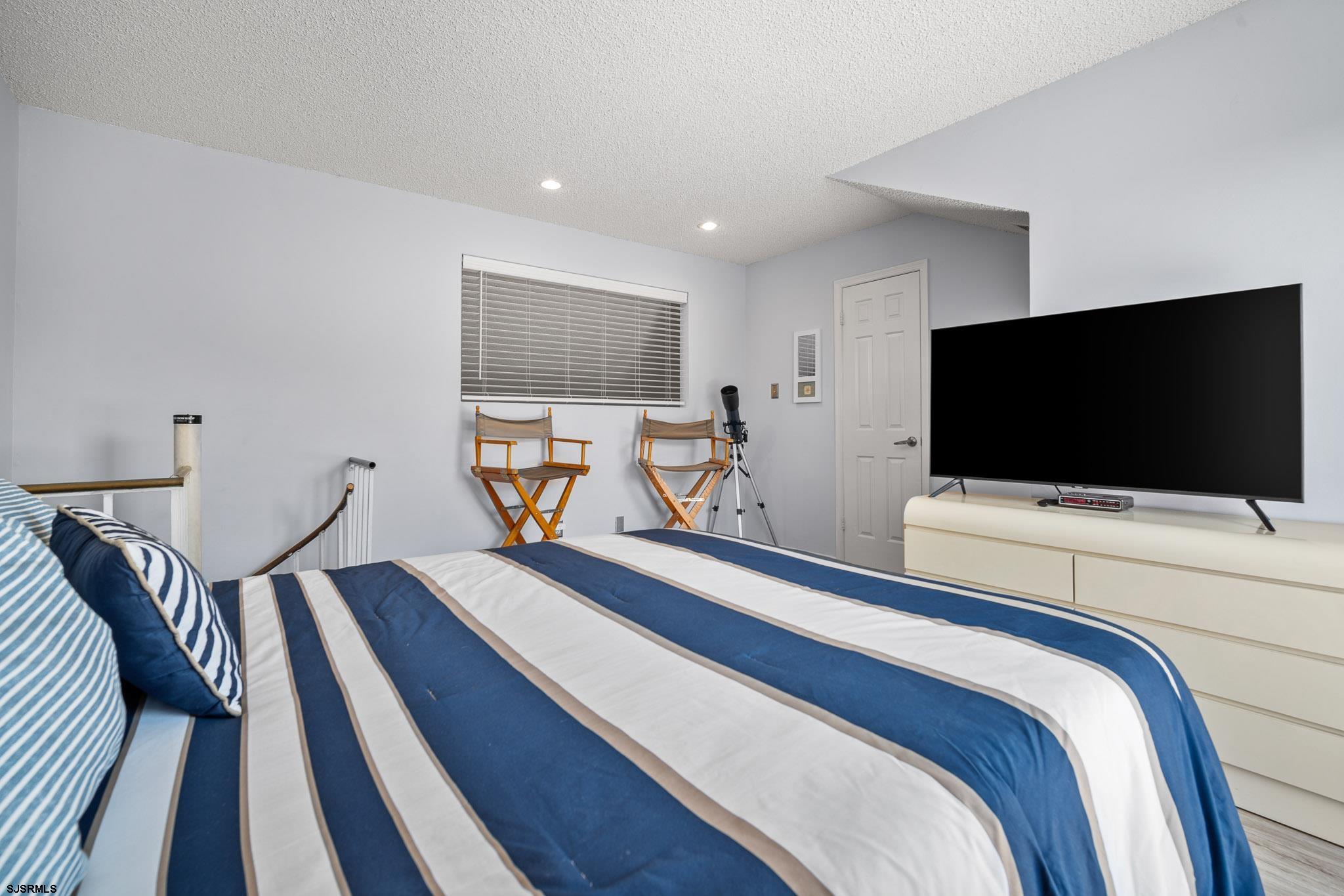 323 44th Street South, Unit 23 Brigantine, NJ 08203 - Photo 22 of 33 a bedroom with a bed and a flat screen tv