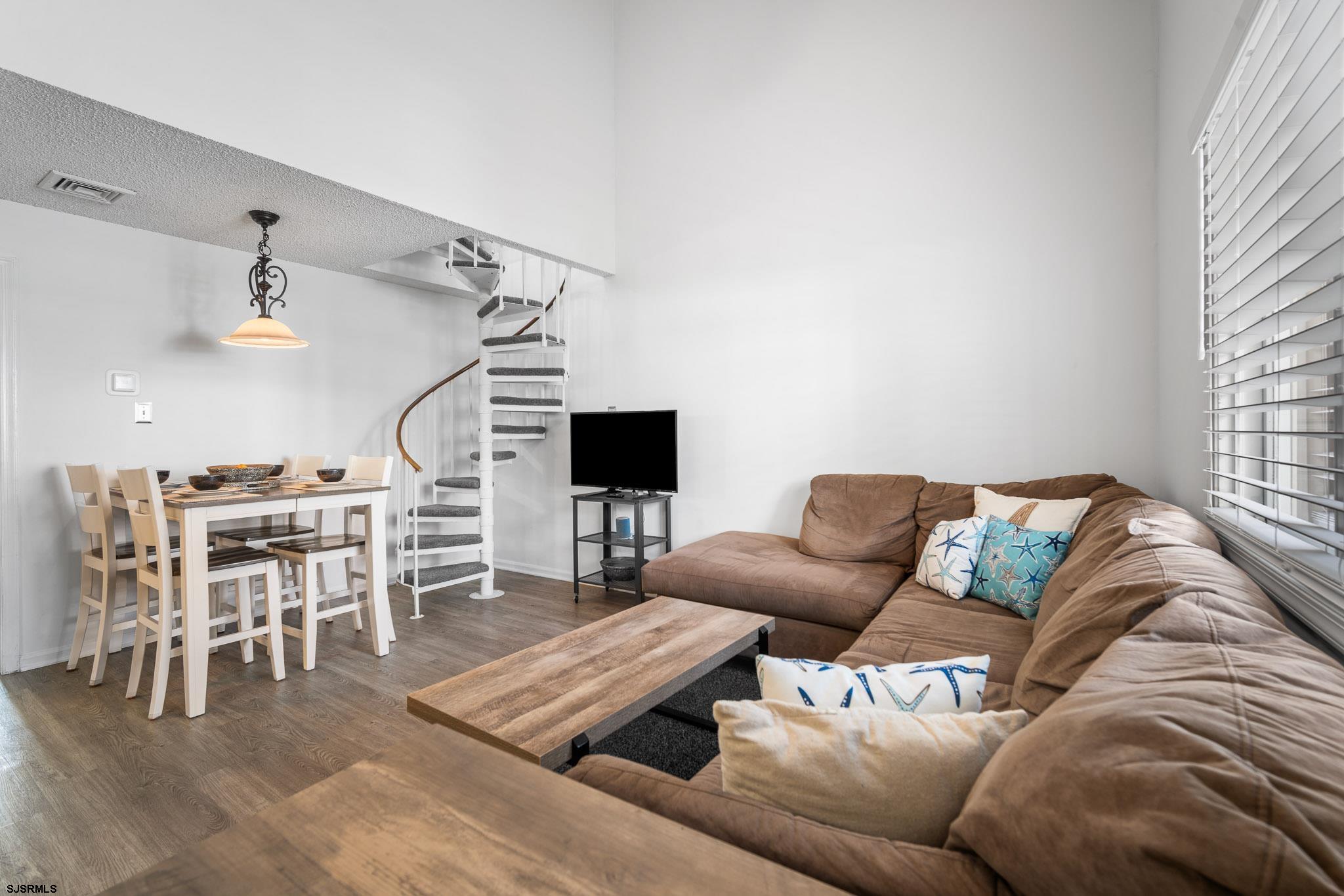 323 44th Street South, Unit 23 Brigantine, NJ 08203 - Photo 4 of 33 a living room with furniture and a flat screen tv