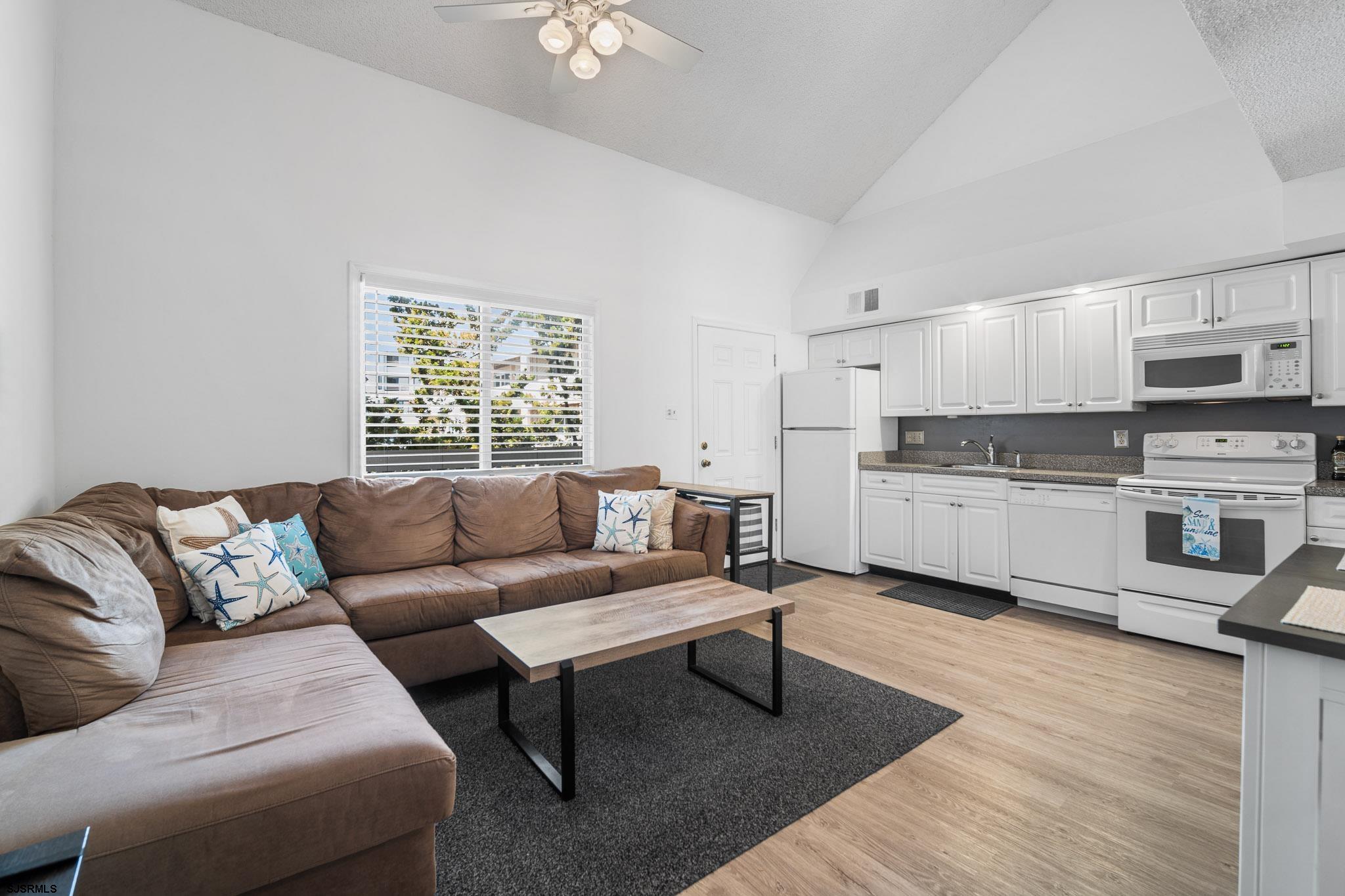 323 44th Street South, Unit 23 Brigantine, NJ 08203 - Photo 5 of 33 a living room with furniture and a fireplace