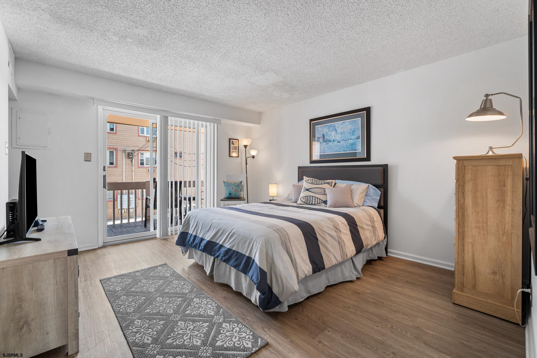 323 44th Street South, Unit 23 Brigantine, NJ 08203 - Photo 8 of 33 a spacious bedroom with a large bed and a flat screen tv