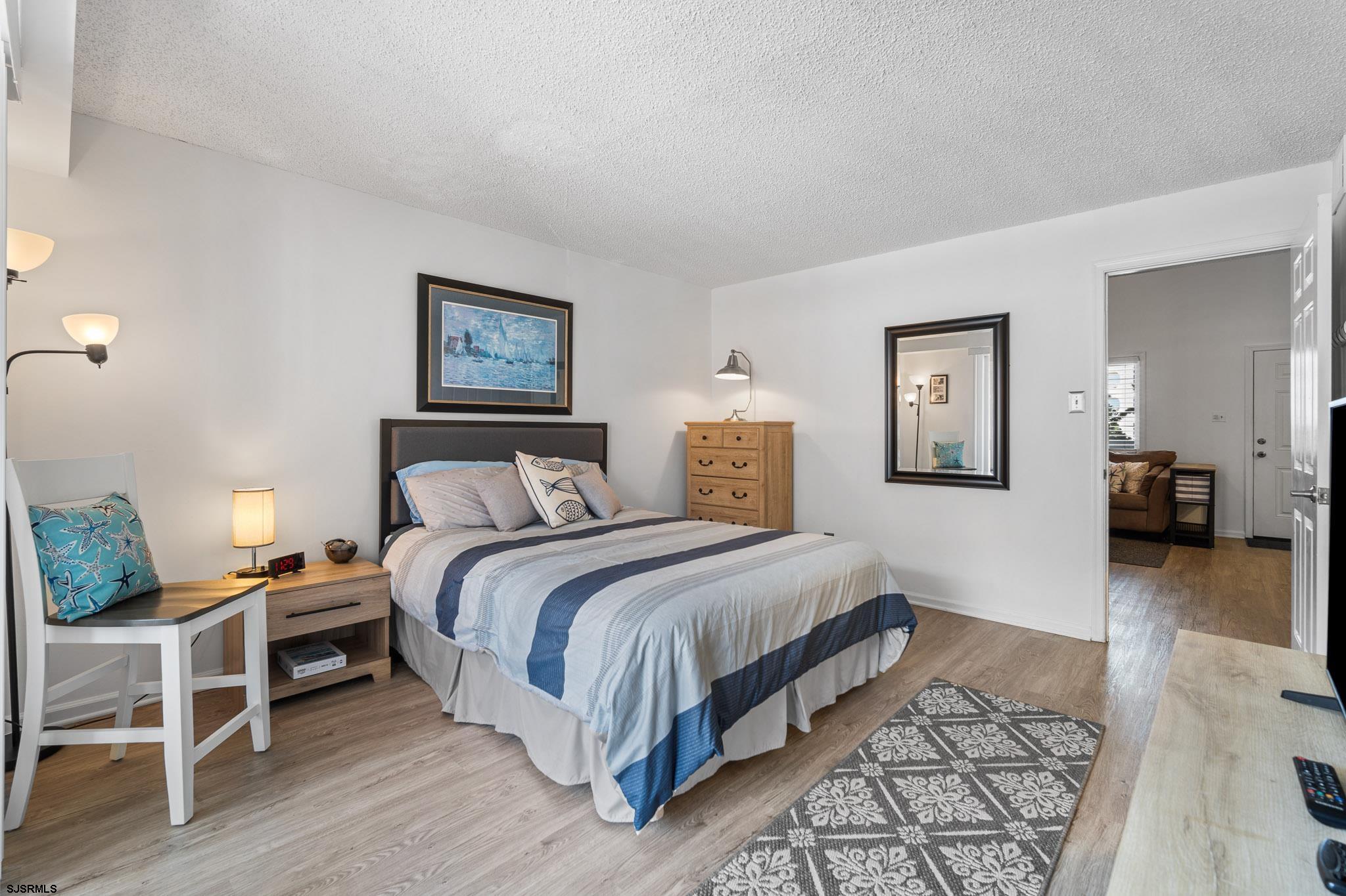 323 44th Street South, Unit 23 Brigantine, NJ 08203 - Photo 10 of 33 a bedroom with a bed and wooden floor