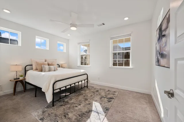 a spacious bedroom with a bed and a window