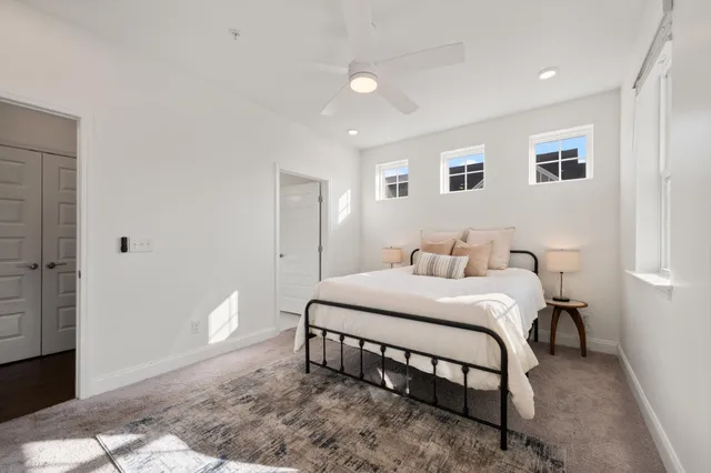 a bedroom with a bed and a potted plant