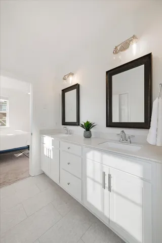 a bathroom with a double vanity sink and mirror