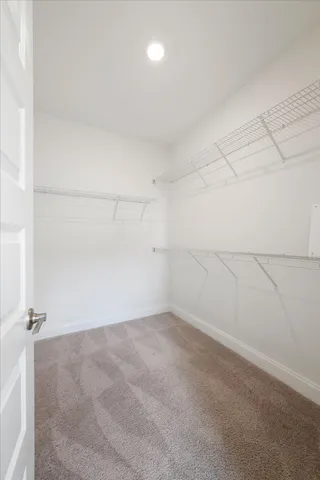 a bedroom with a bed and a night stand