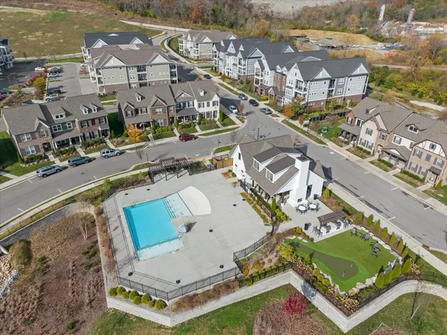 an aerial view of a residential houses with outdoor space