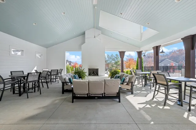 a view of a patio with a table and chairs and a floor to ceiling window