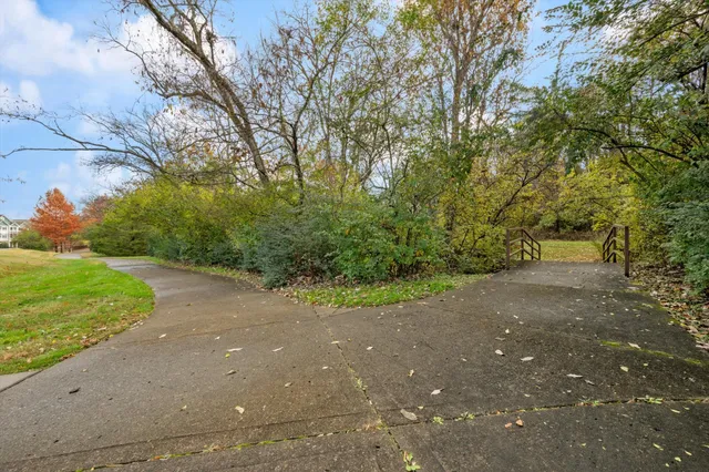 a balcony with wooden floor and trees