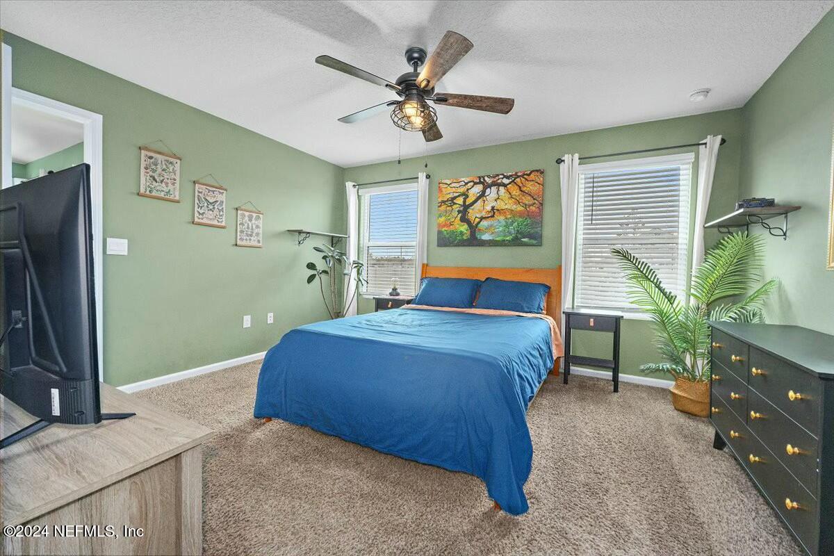 231 Caminha Circle St. Augustine, FL 32084 - Photo 6 of 15 a bedroom with a bed and a flat screen tv