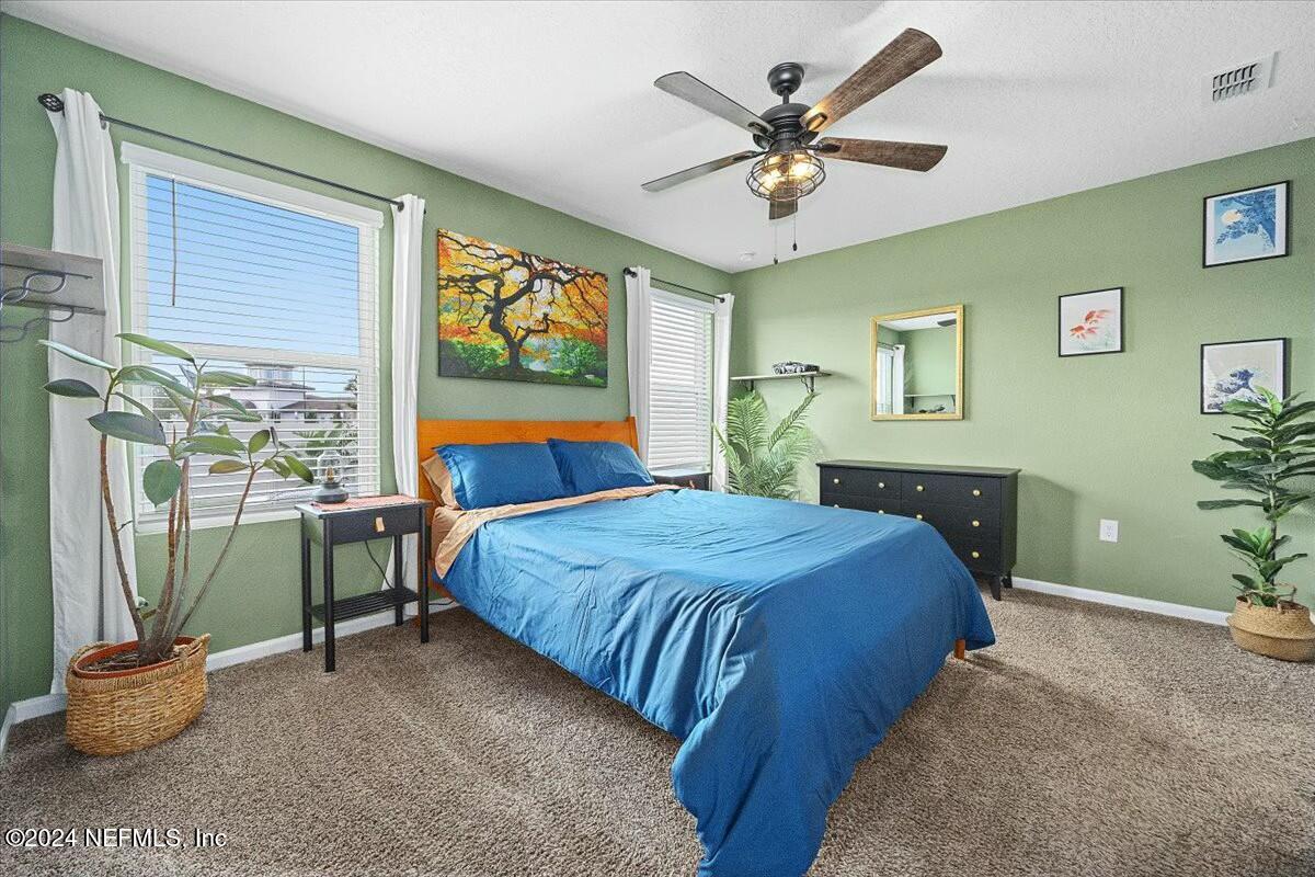 231 Caminha Circle St. Augustine, FL 32084 - Photo 7 of 15 a bedroom with a bed and a large window