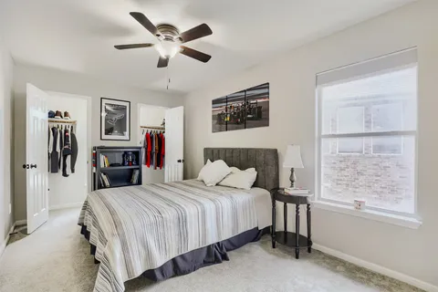 a bedroom with a large bed and a window
