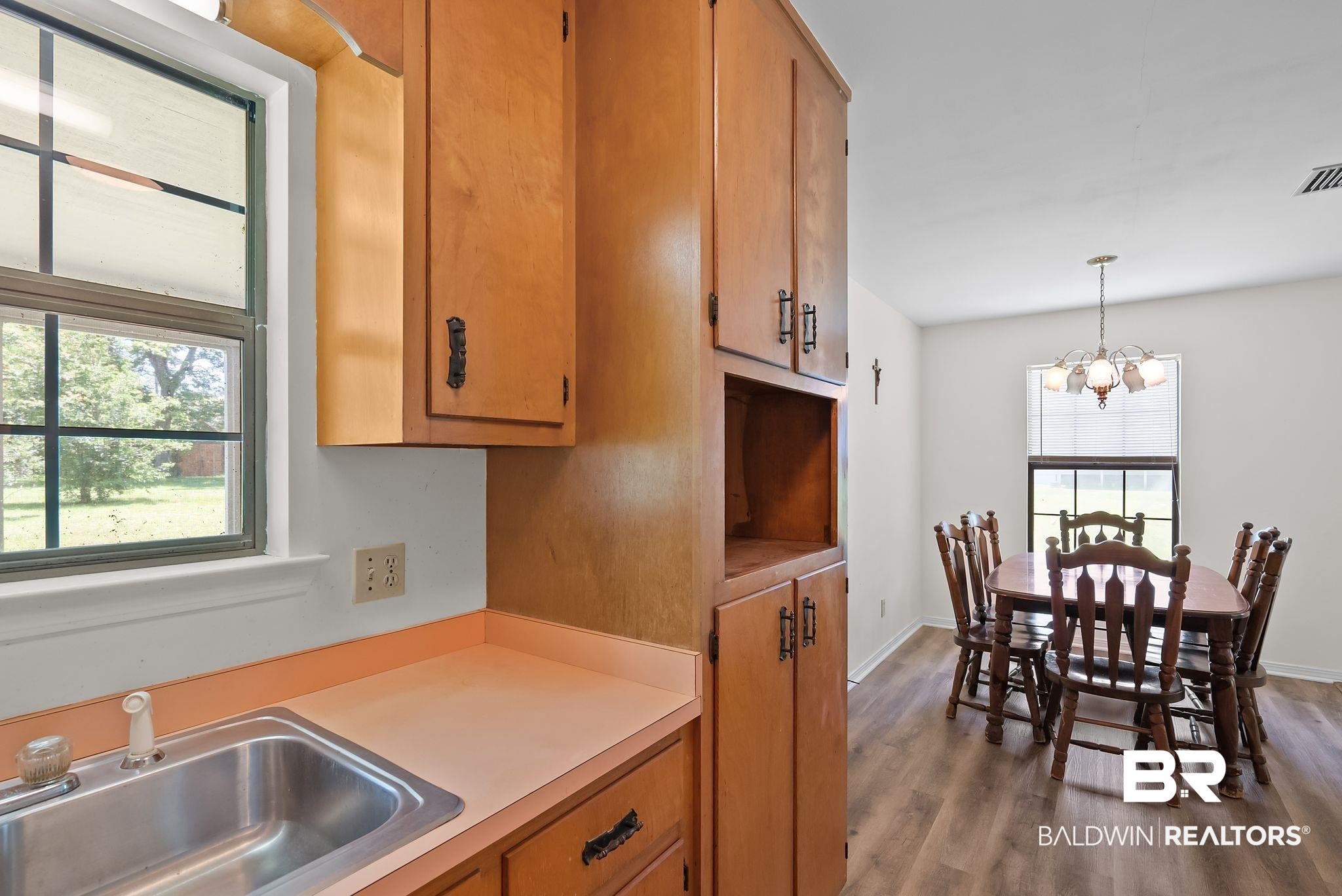 20540 Lacey Road Silverhill, AL 36576 - Photo 12 of 40 Kitchen area featuring wood-finish cabinetry, a stainless steel sink, and a window