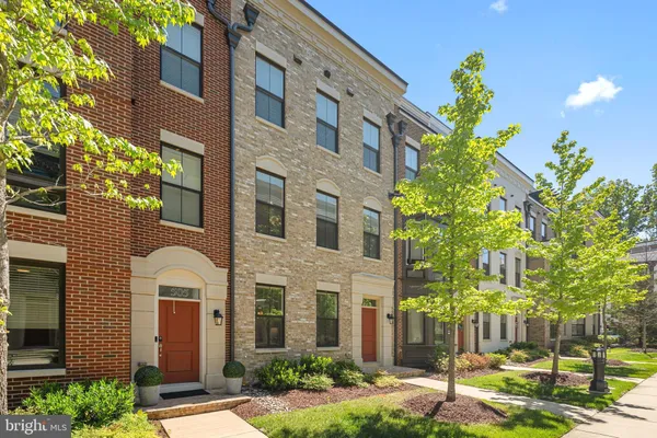 a view of a brick building next to a yard
