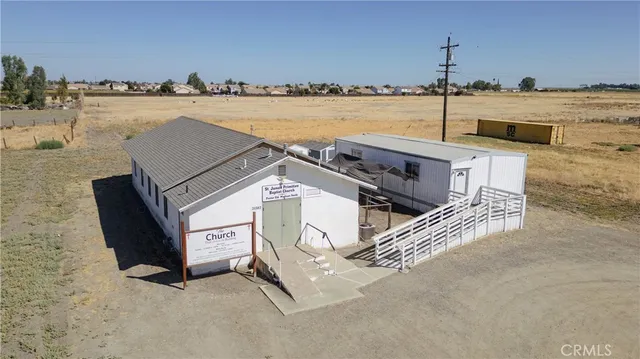 an aerial view of a house with a ocean beach
