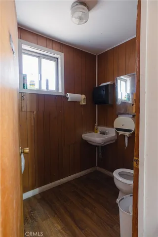 a room with lots of tables a large window and chairs