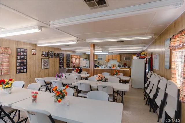 a kitchen with granite countertop lots of clutter and stainless steel appliances