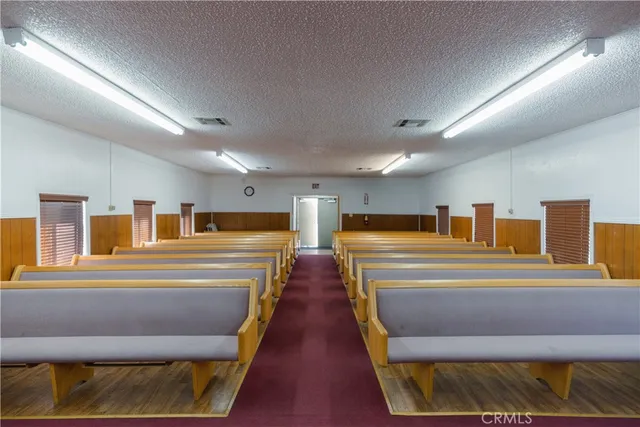a kitchen with furniture a refrigerator and a stove top oven