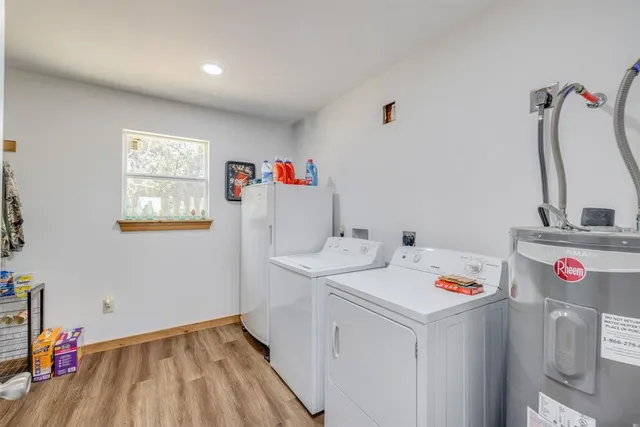a utility room with sink dryer and washer