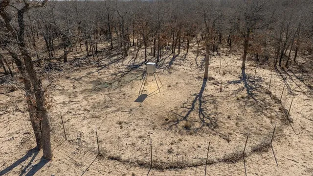 an aerial view of a house with a yard and lake view